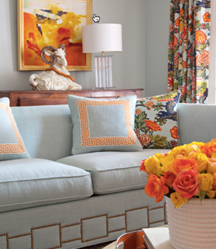 I love this sofa and the pops of orange!